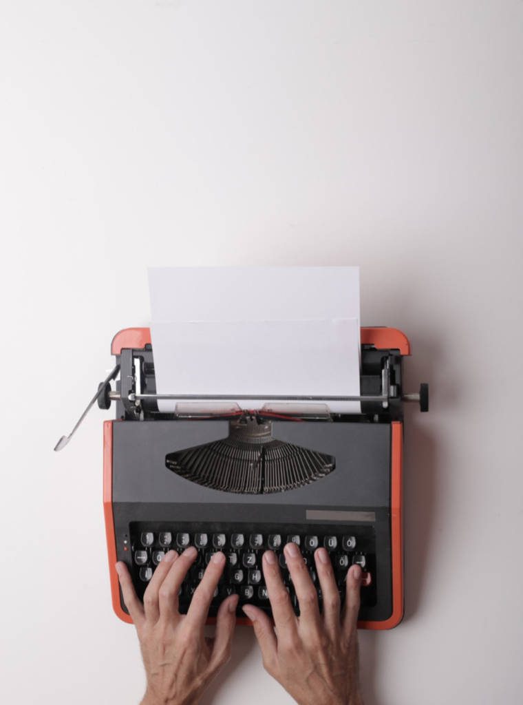 A typewriter with a blank piece of paper inside
