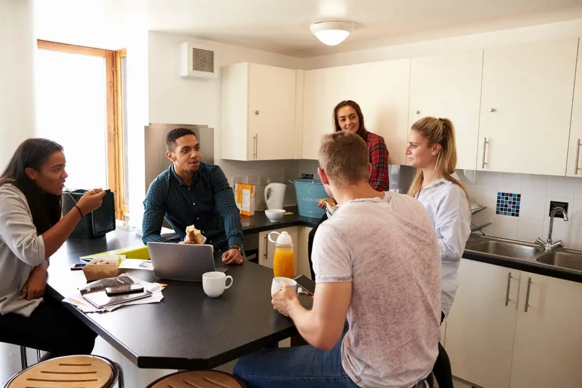 Students socialising in a shared accommodation kitchen