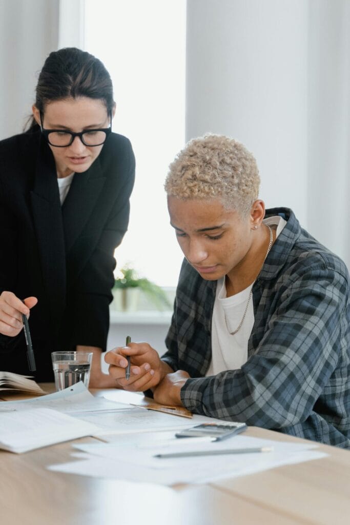 teacher and student looking at a workbook