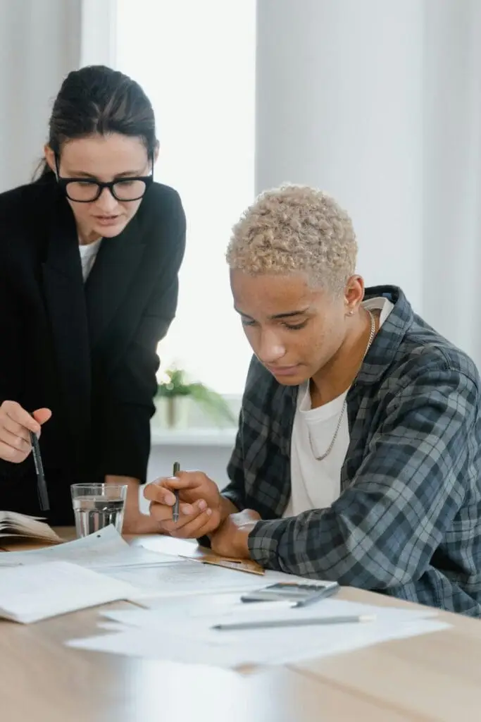 teacher and student looking at a workbook