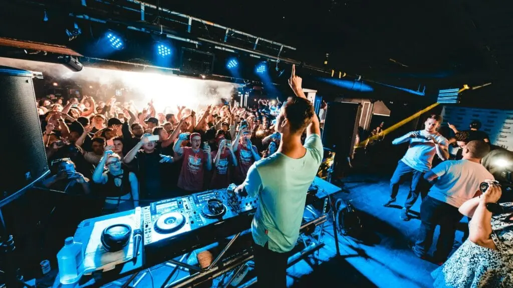 Photo of DJ and crowd at a club