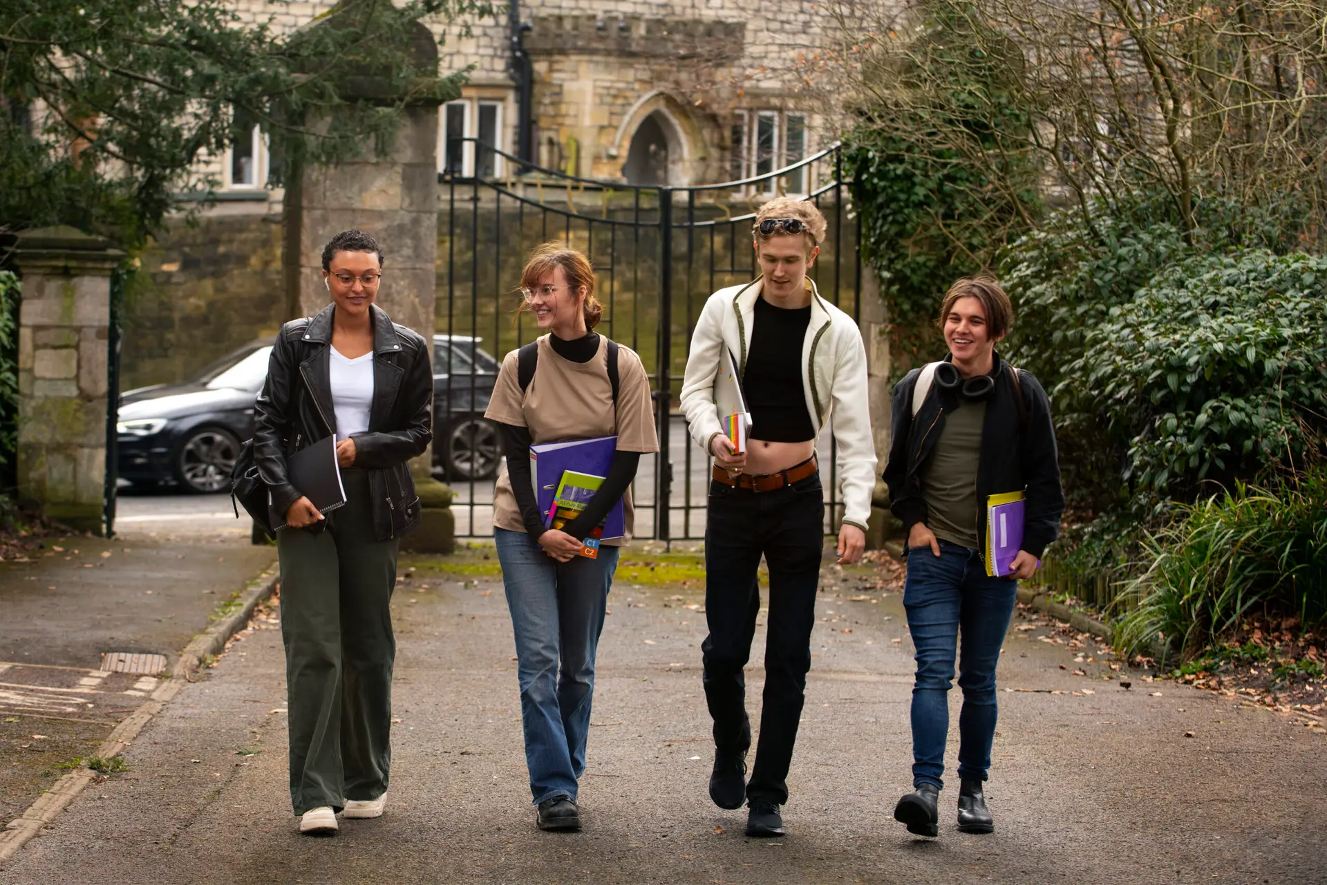 Four university students walking around on campus