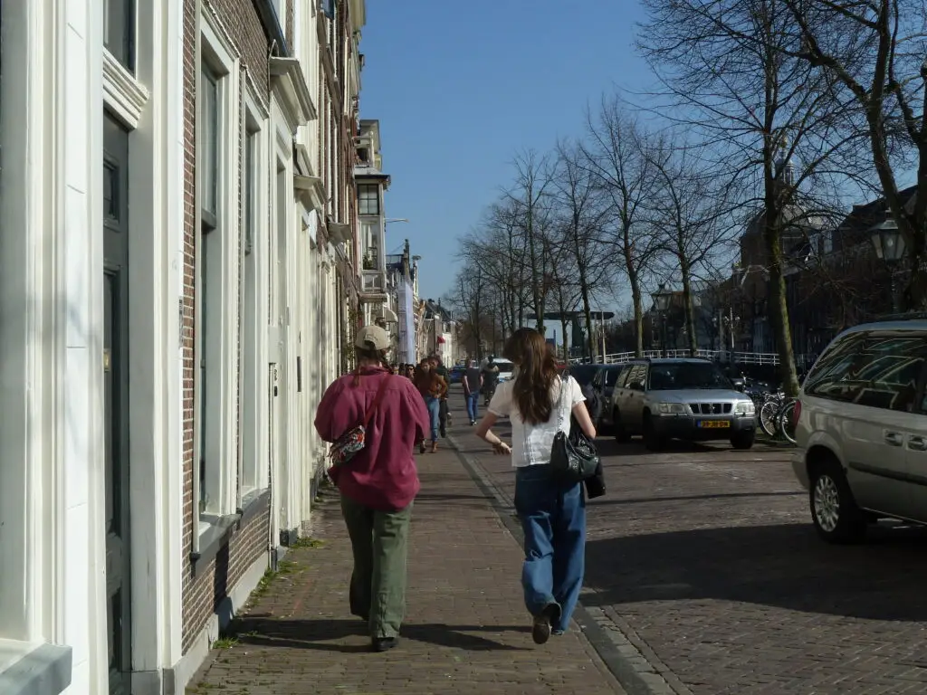 Two friends walking through a quiet street in Leiden, Netherlands