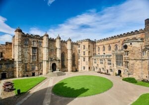A view of Durham Castle from its courtyard on a sunny day.