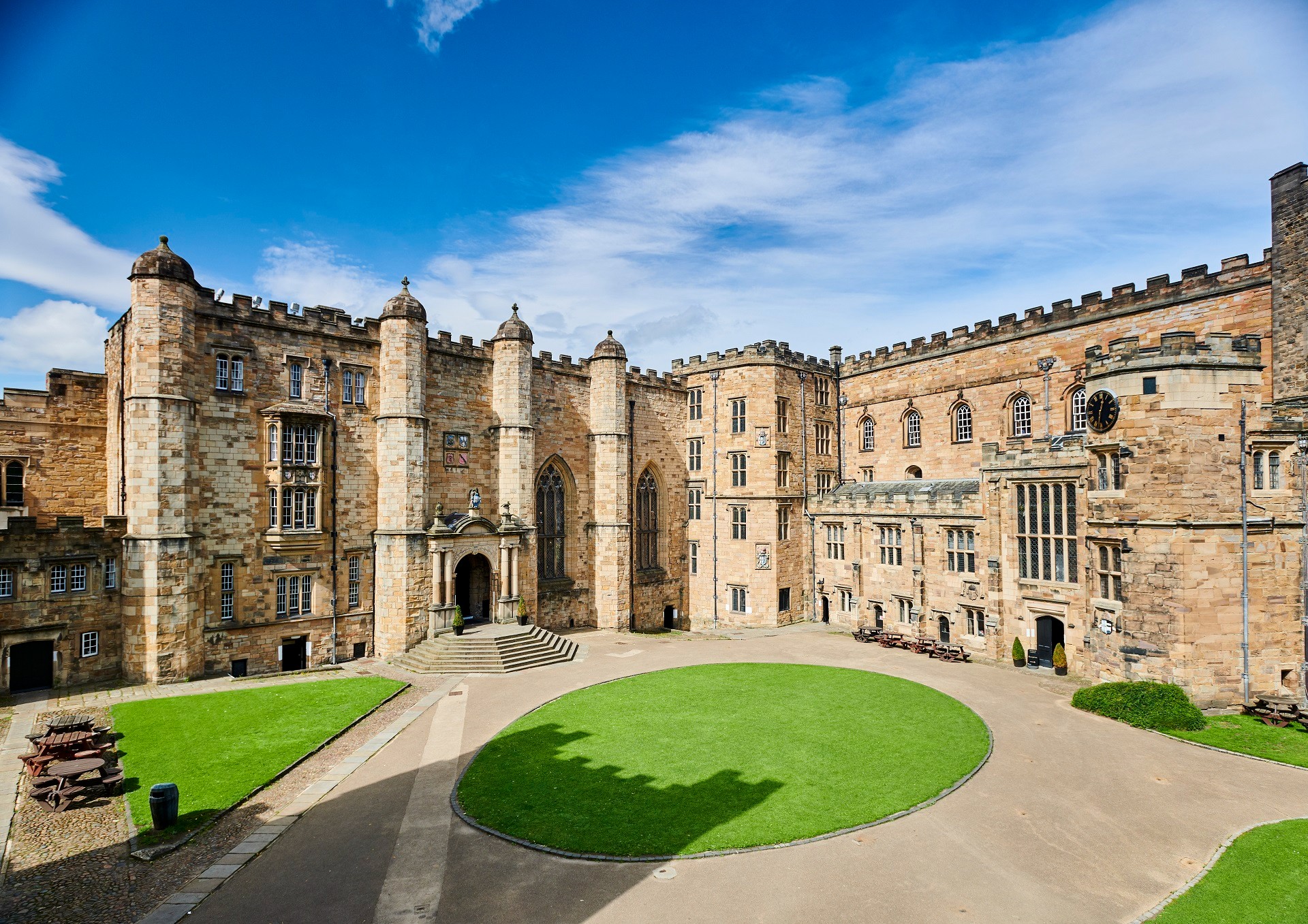 A view of Durham Castle from its courtyard on a sunny day.