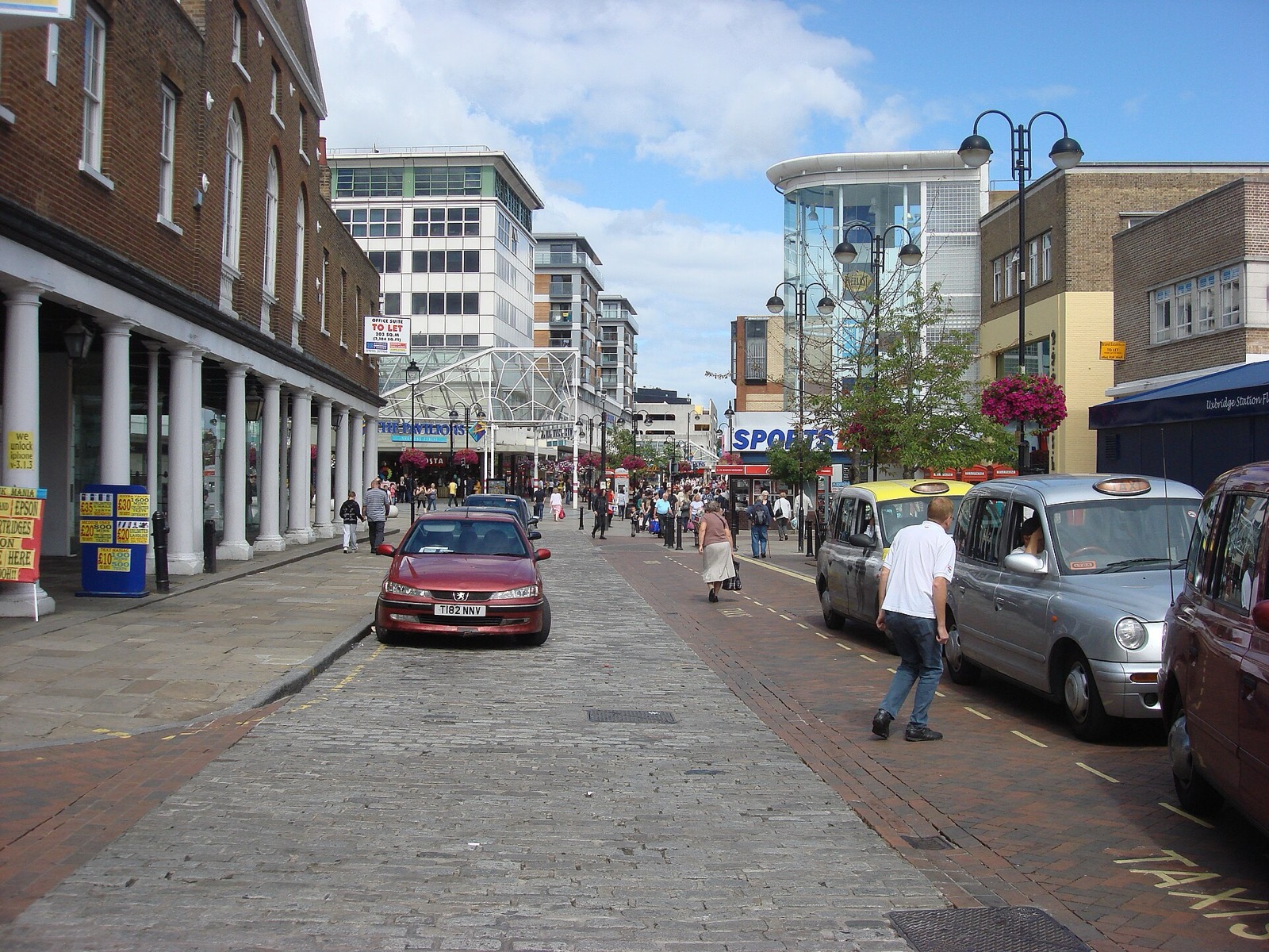 Pedestrianised High Street in Uxbridge town centre on a sunny day