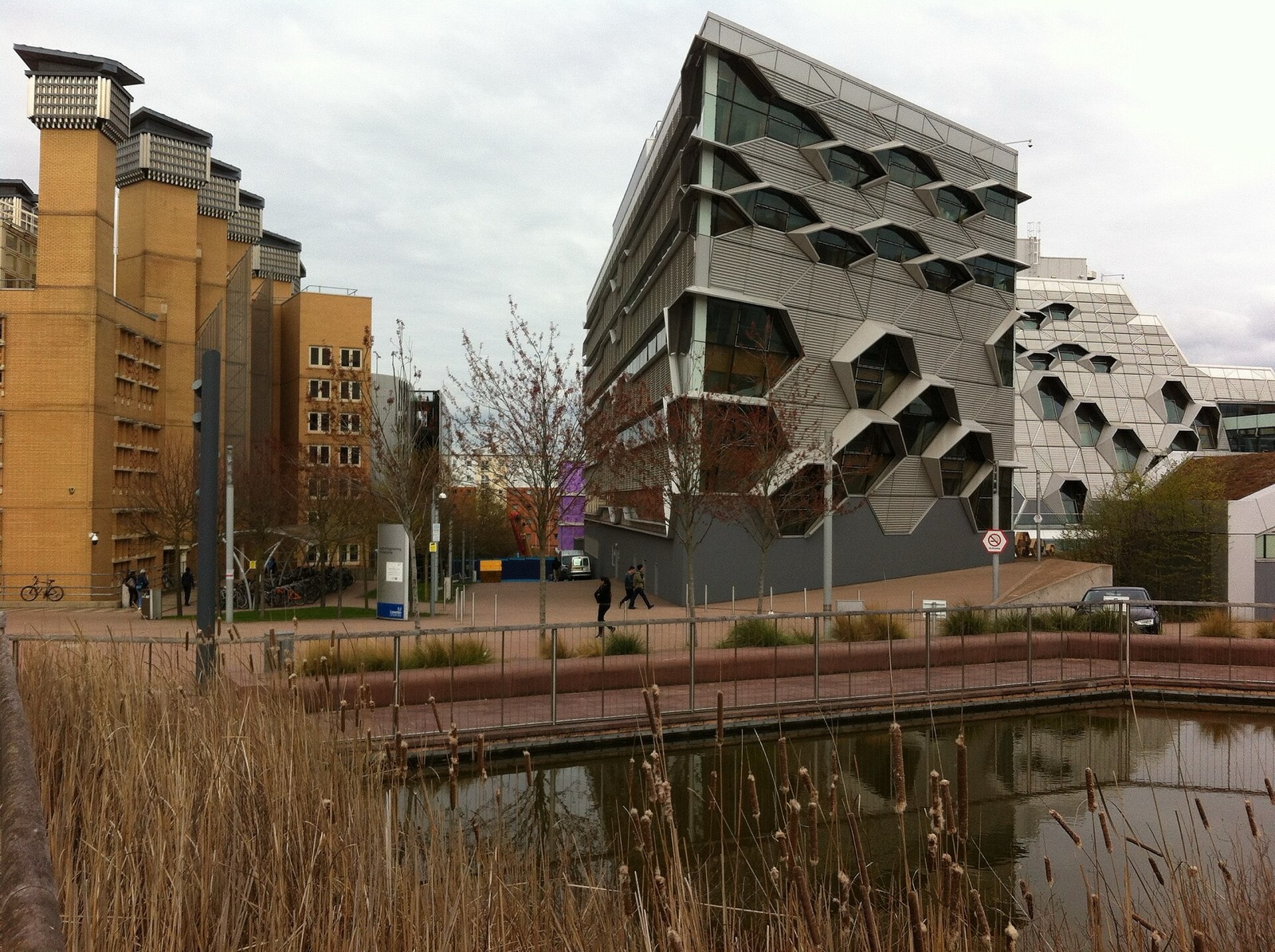Coventry University's Lanchester Library and The Hub seen across a pond in the city centre campus