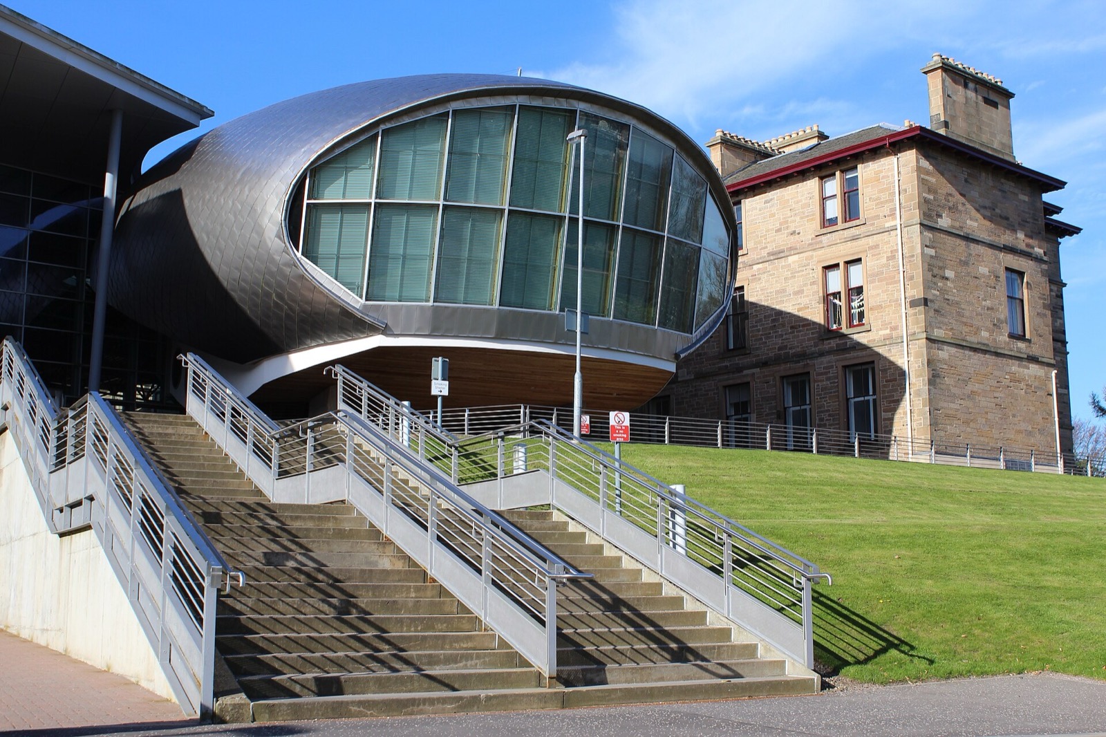 Modern glass extension beside the historic building at Edinburgh Napier University's Craiglockhart campus