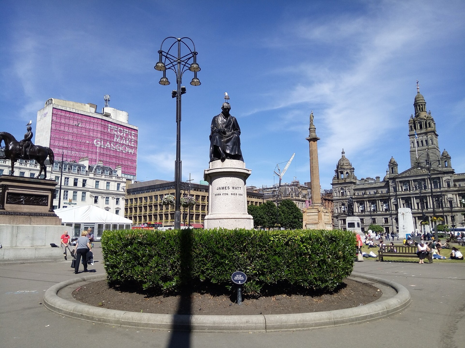 George Square in Glasgow city centre on a sunny day, with the City Chambers behind