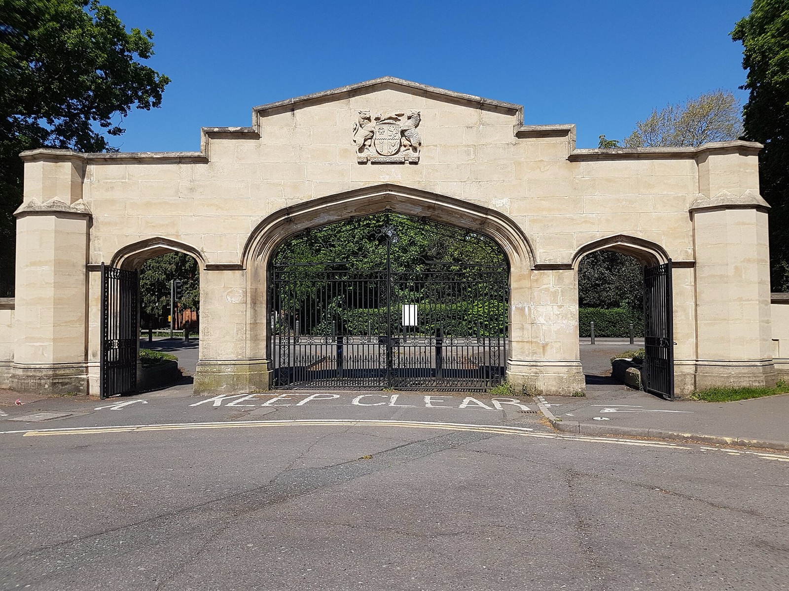 The stone entrance arch at Loughborough University under a blue sky